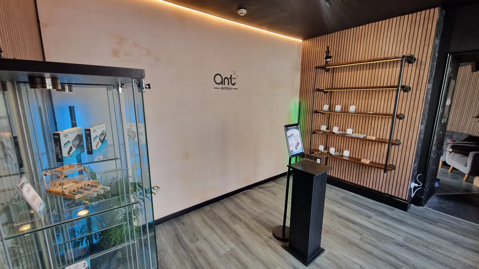 The shop floor, with nests in a glass cabinet and the logo on the wall.